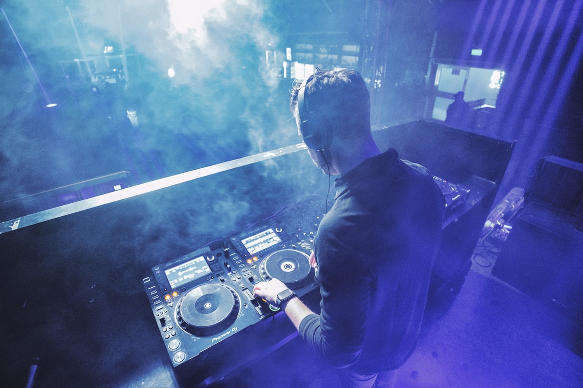 DJ performing behind a mixing desk